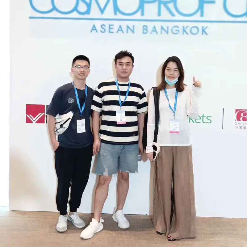 JTING professional team members posing at a beauty exhibition in Thailand, representing Guangzhou Jingting Cosmetics' international trade presence in Southeast Asia.