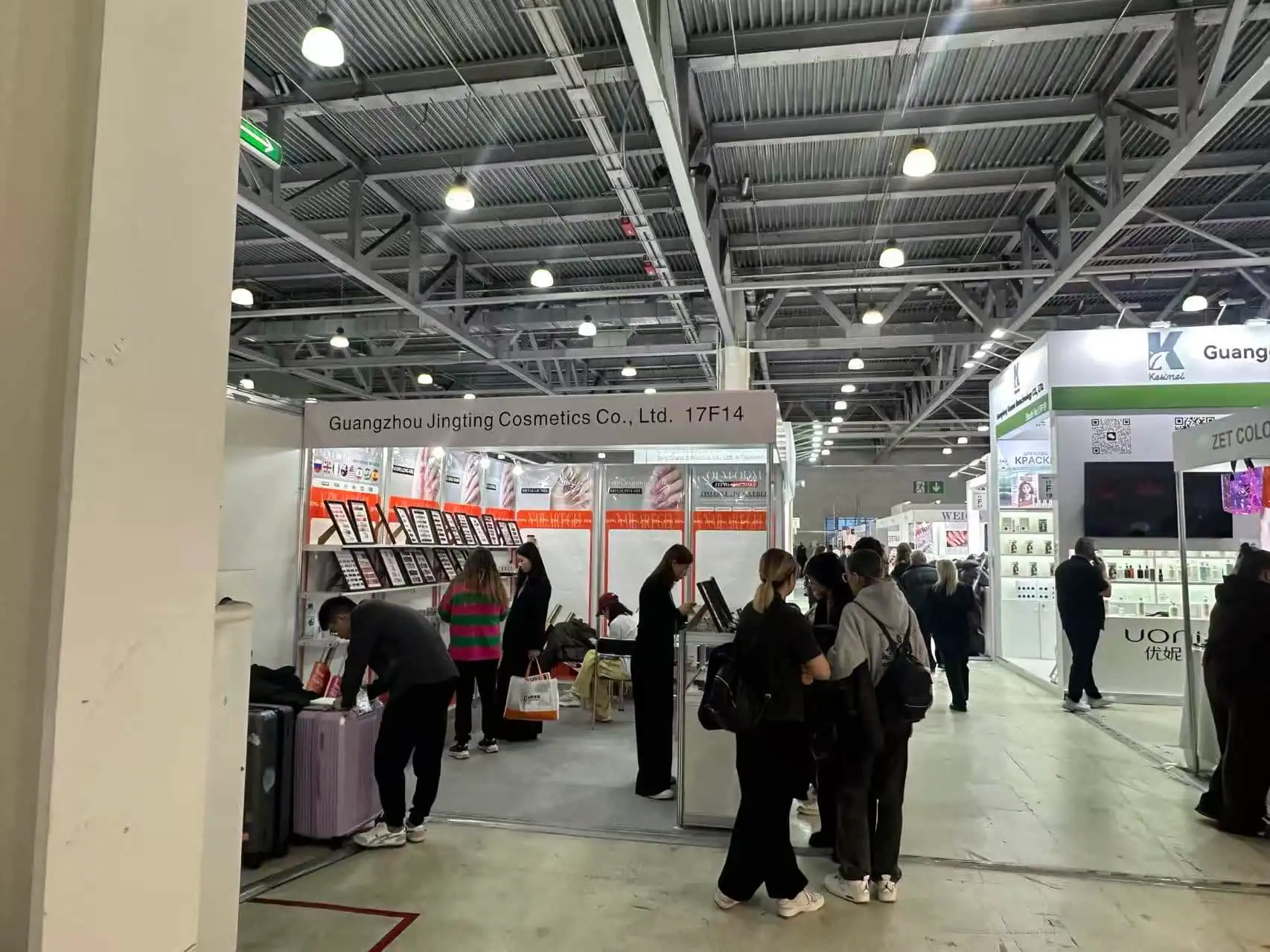 Guangzhou Jingting Cosmetics Co., Ltd. trade show booth at a professional beauty exhibition in Italy, demonstrating JTING's global presence and extensive range of OEM/ODM nail gel products.