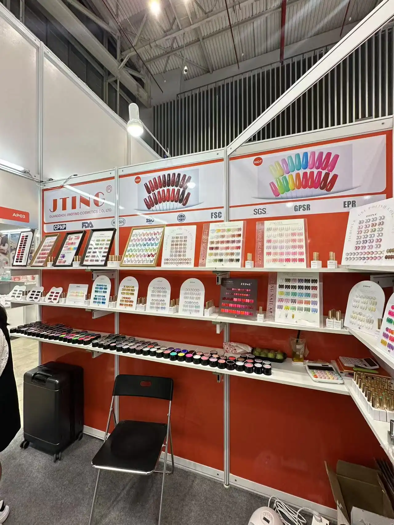 JTING (Guangzhou Jingting Cosmetics Co., Ltd.) professional trade show booth at a premier beauty exhibition in the USA, showcasing a comprehensive range of OEM/ODM UV/LED gel polish products and factory-price manufacturing services for global brands.