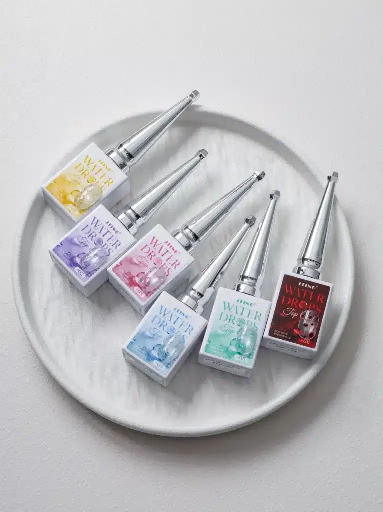 Wholesale supply of 15ml JTING HEMA free and TPO free water drops top coat bottles on a plate