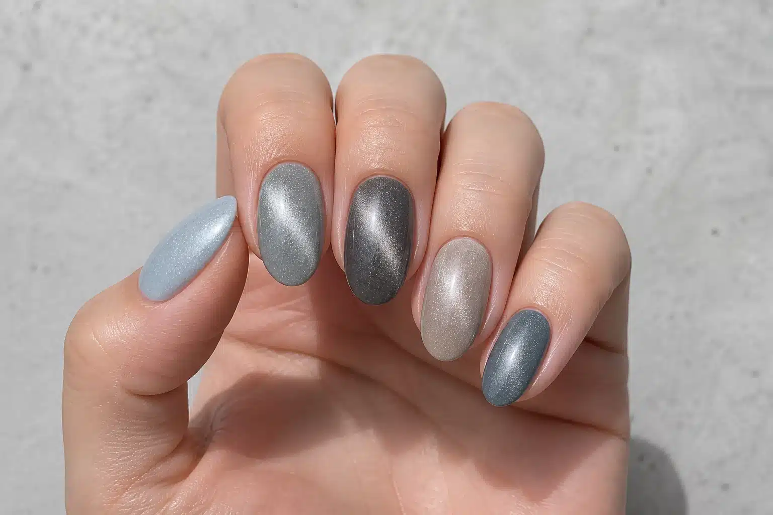 JTING A12 smoky taupe gray and greige magnetic gel polish shown on a hand