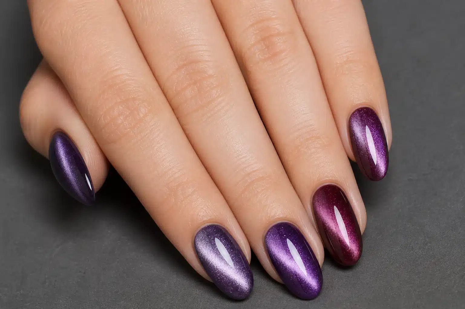 JTING W07 purple burgundy velvet cat eye gel nail polish shown on a hand