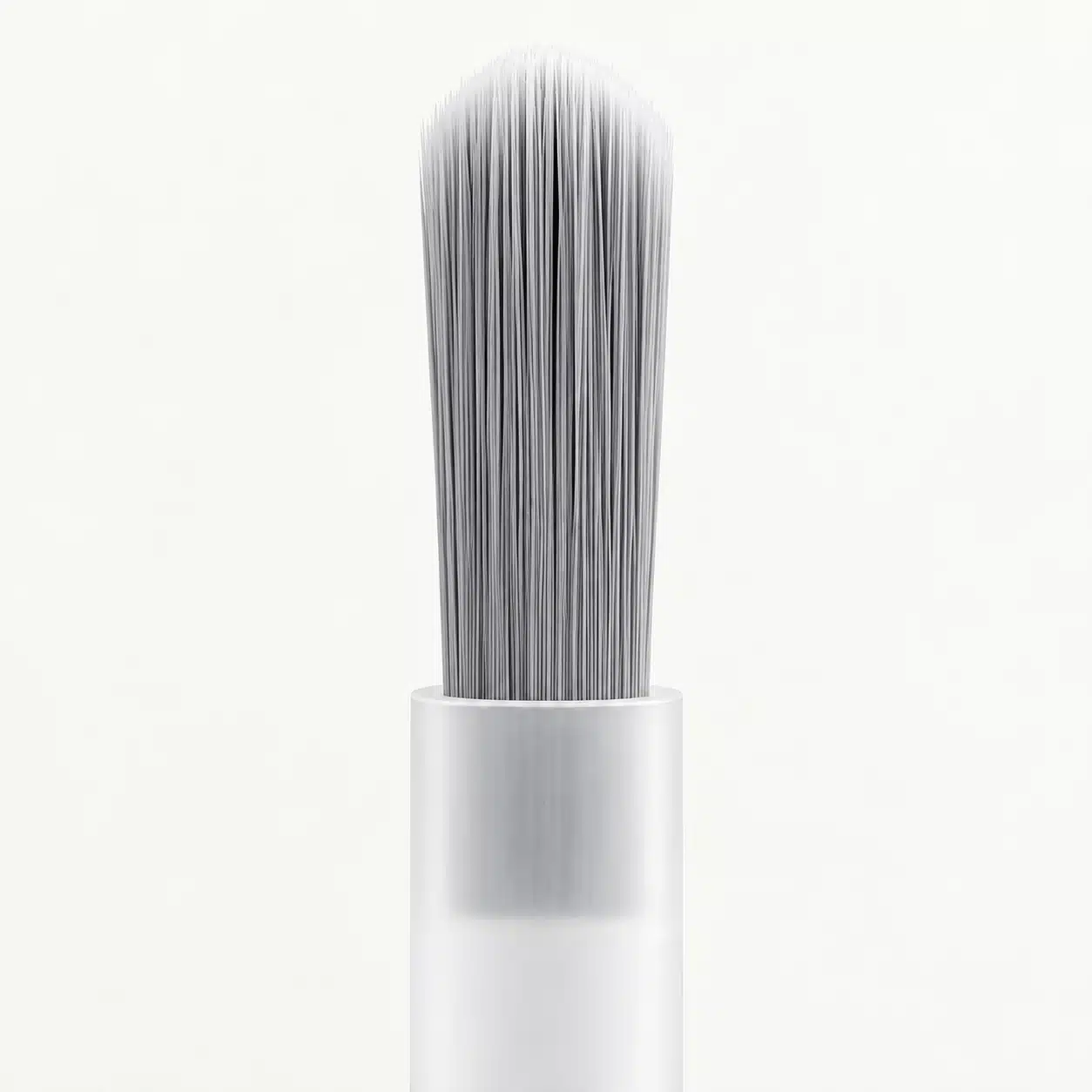 Gray bottle brush with a rounded bristle edge and translucent plastic stem.