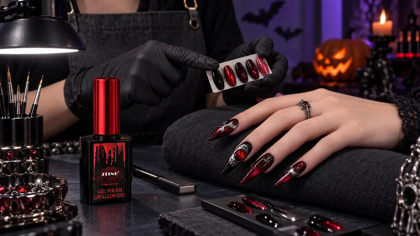 Nail technician and client reviewing Halloween nail designs and application materials at a salon workstation