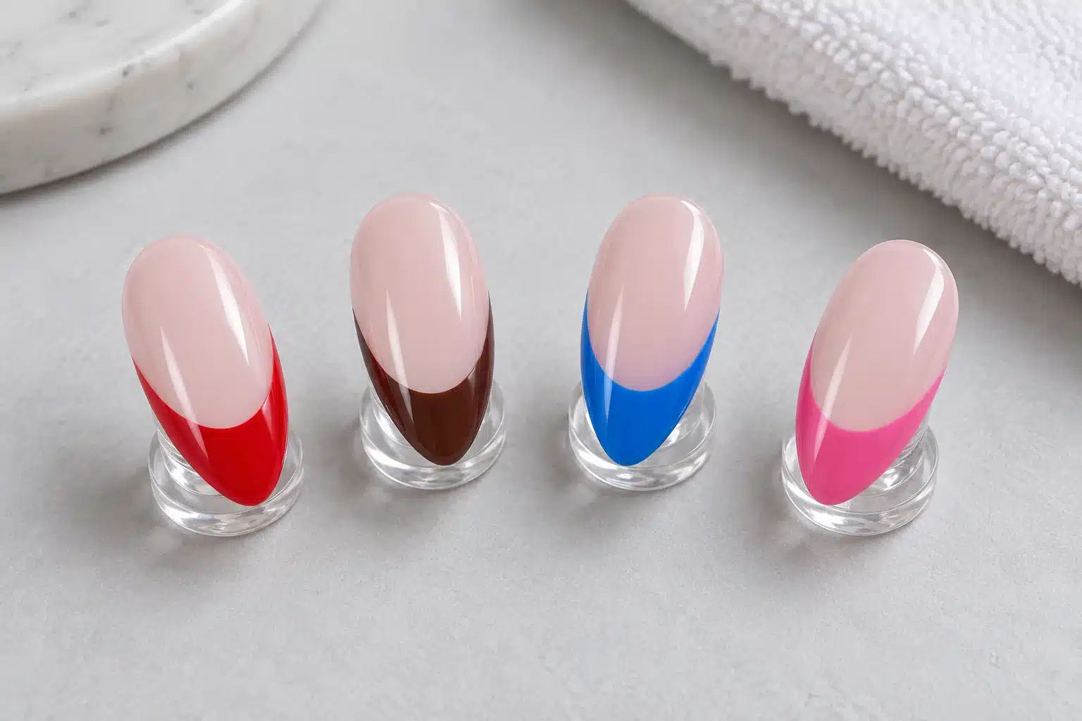 Red, brown, blue and pink French tips on matching nude pink almond nail samples