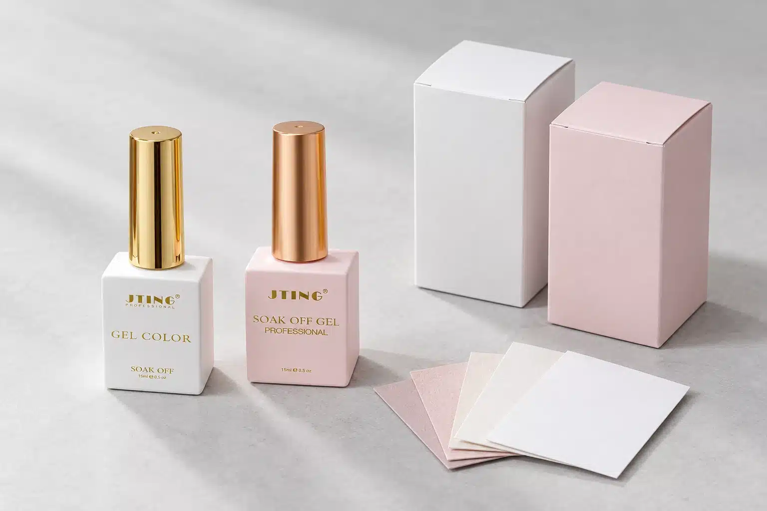 White and pink gel nail polish bottles with gold and rose-gold caps beside blank carton mockups