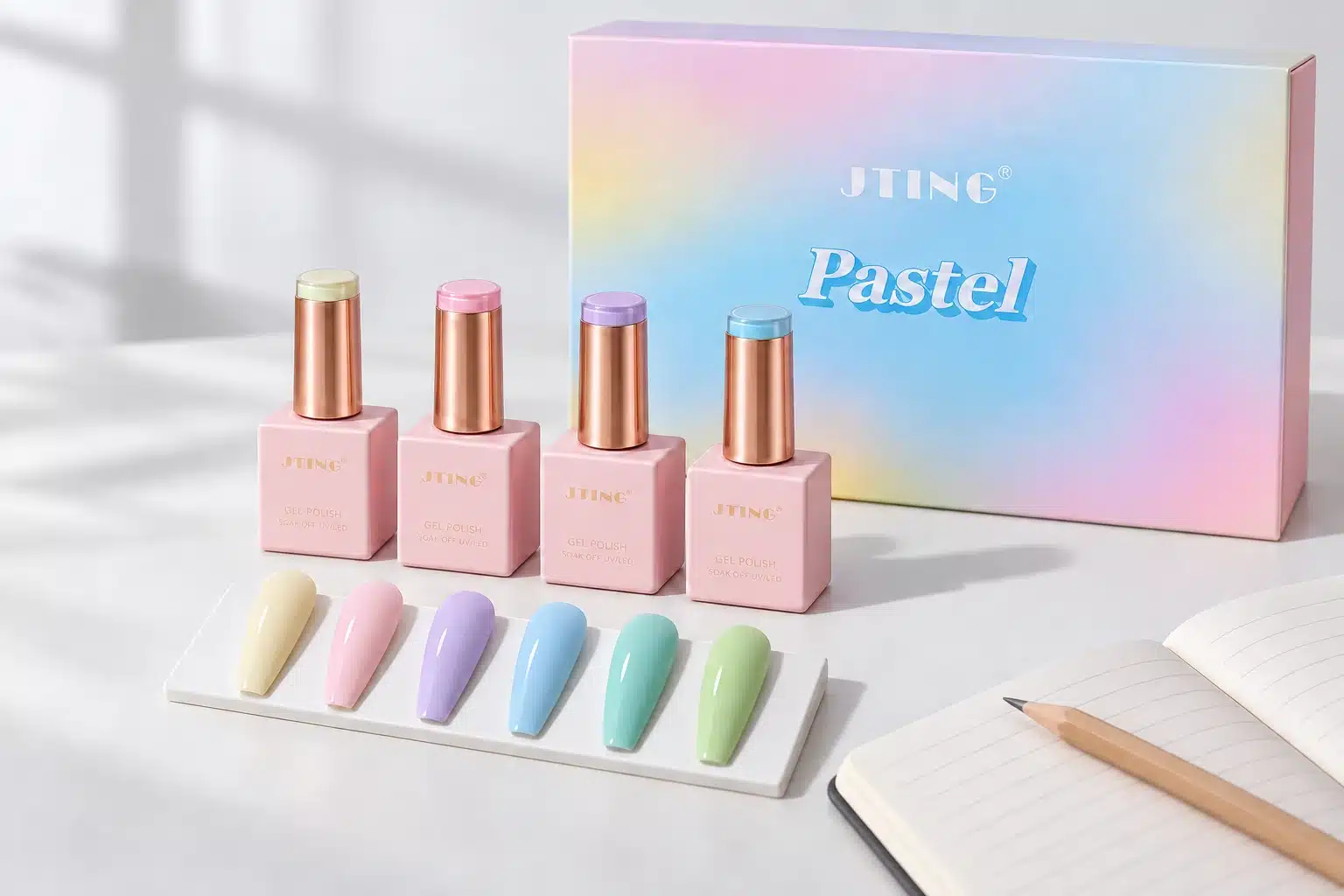 Pastel gel nail polish bottles, six selected nail swatches and matching packaging on a collection planning desk