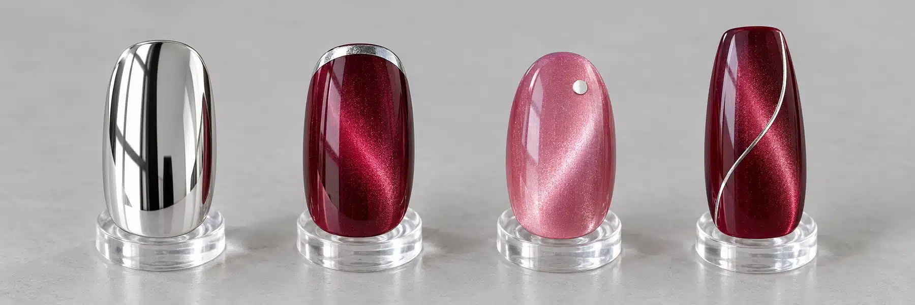 Full silver mirror nail compared with burgundy and pink cat eye nails featuring silver accents