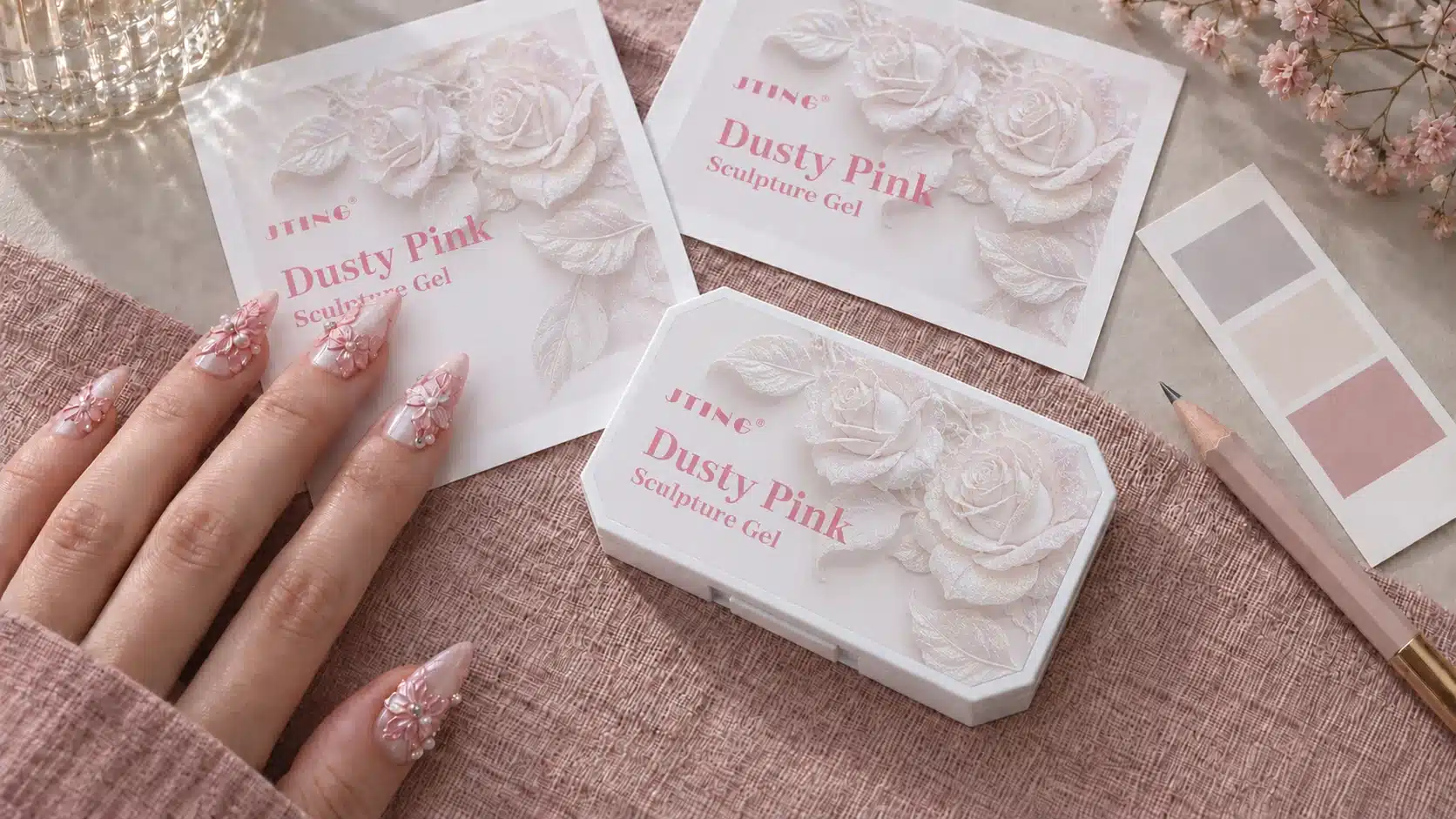 JTING Dusty Pink Sculpture Gel palette with its floral lid design beside matching artwork sheets and a floral manicure.