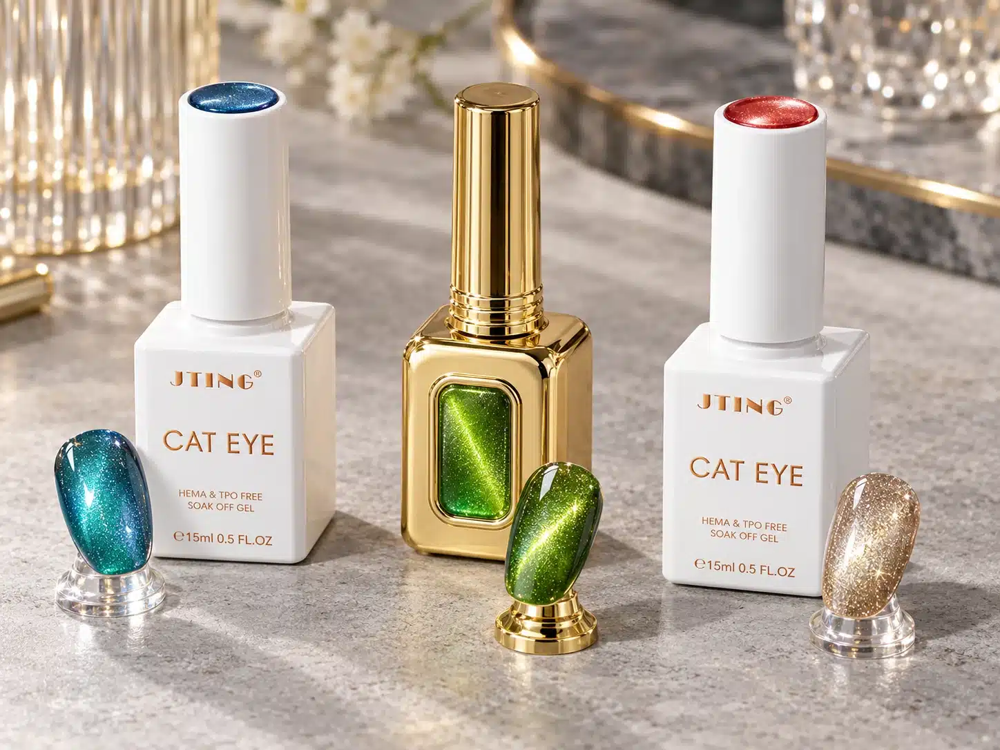 White and gold JTING cat eye gel bottles with teal, green and champagne magnetic nail samples