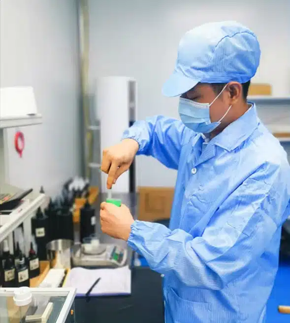 JTING technician working at a gel nail polish production workstation