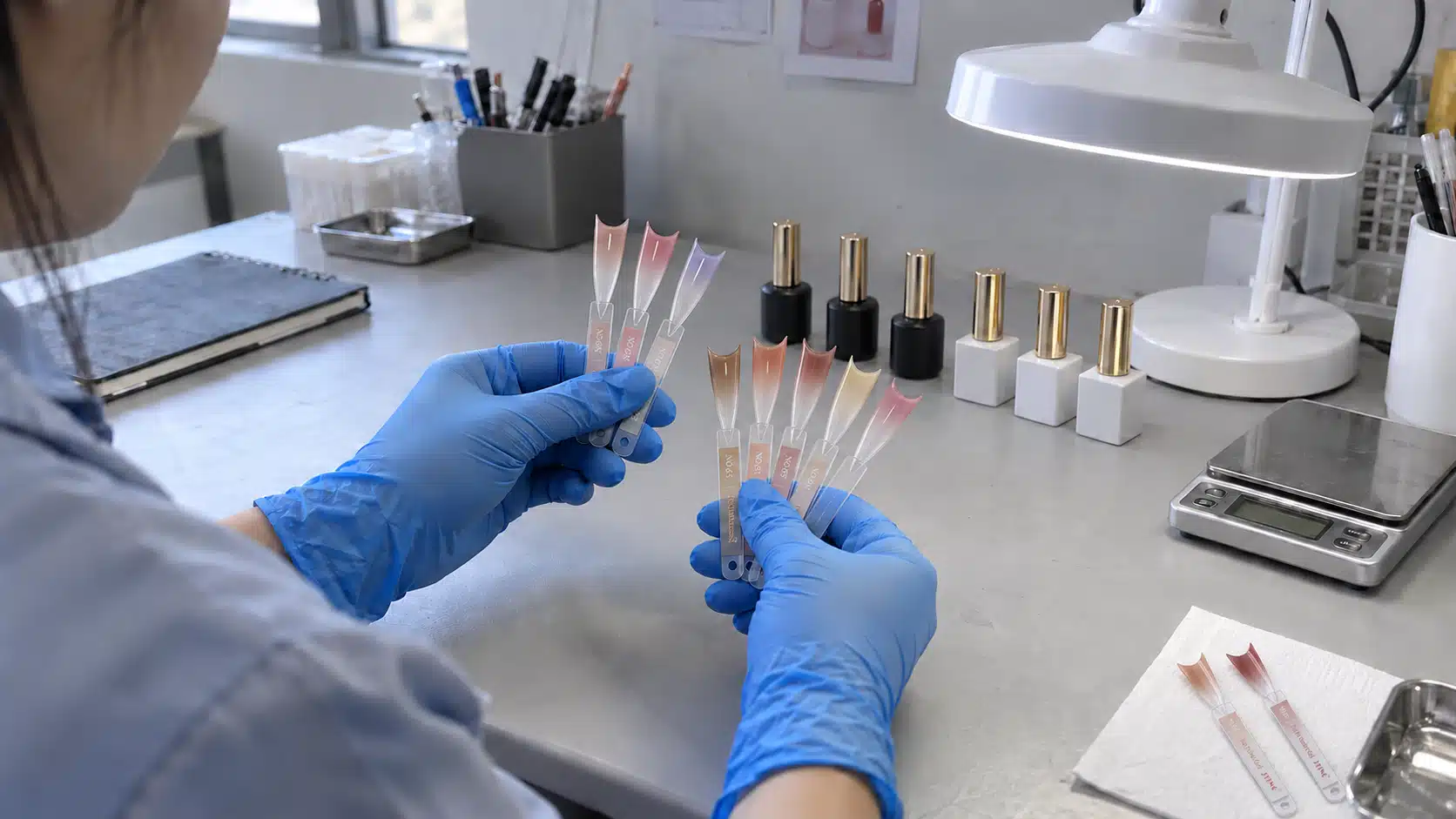 Comparing gel nail polish colors on clear swatch sticks