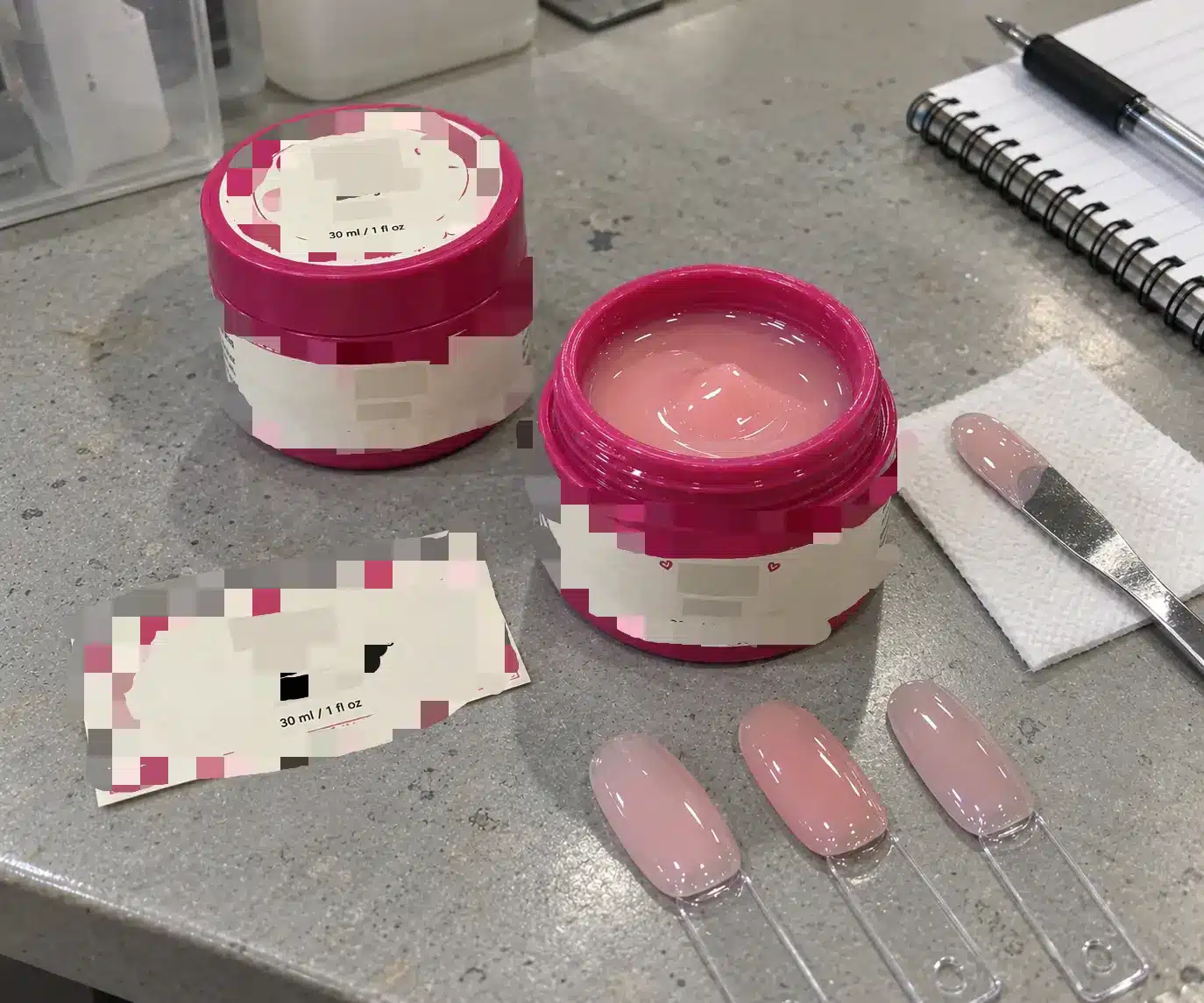 Private label builder gel jars with floral labels and pink nail swatches