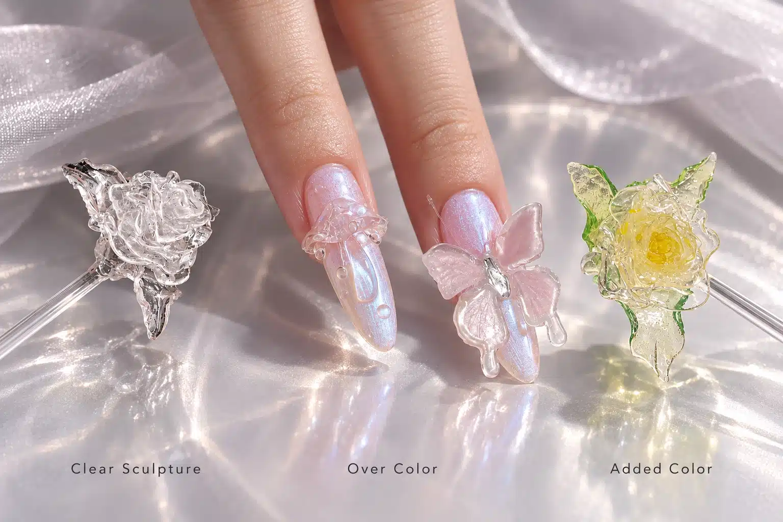 Clear sculpted rose, transparent nail decorations over iridescent pink, and a rose with added yellow and green color