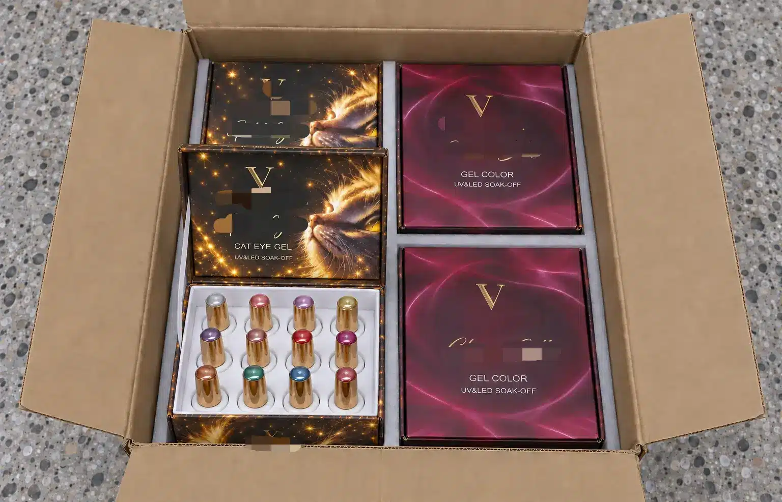 Four branded gel nail polish collection boxes packed inside a shipping carton, with one box open.